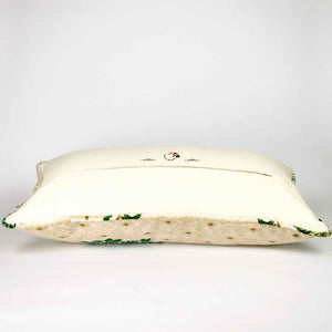 Large pillow with oriental look. The pillow has traditional green moroccan pattern on a beige canvas background. The back of the large pillow is shown.