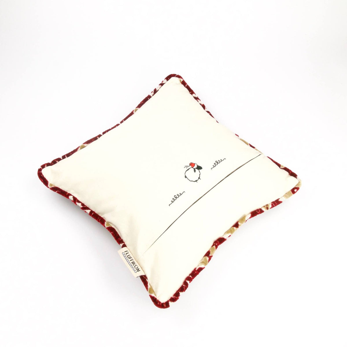 The back of a Fluffikon moroccan couch cushion showing a stitched Lalla Soffa.