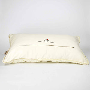 Fluffikon oversized lumbar pillow made from beige velvet with golden threads. The pillow is shown from the back lying on the ground