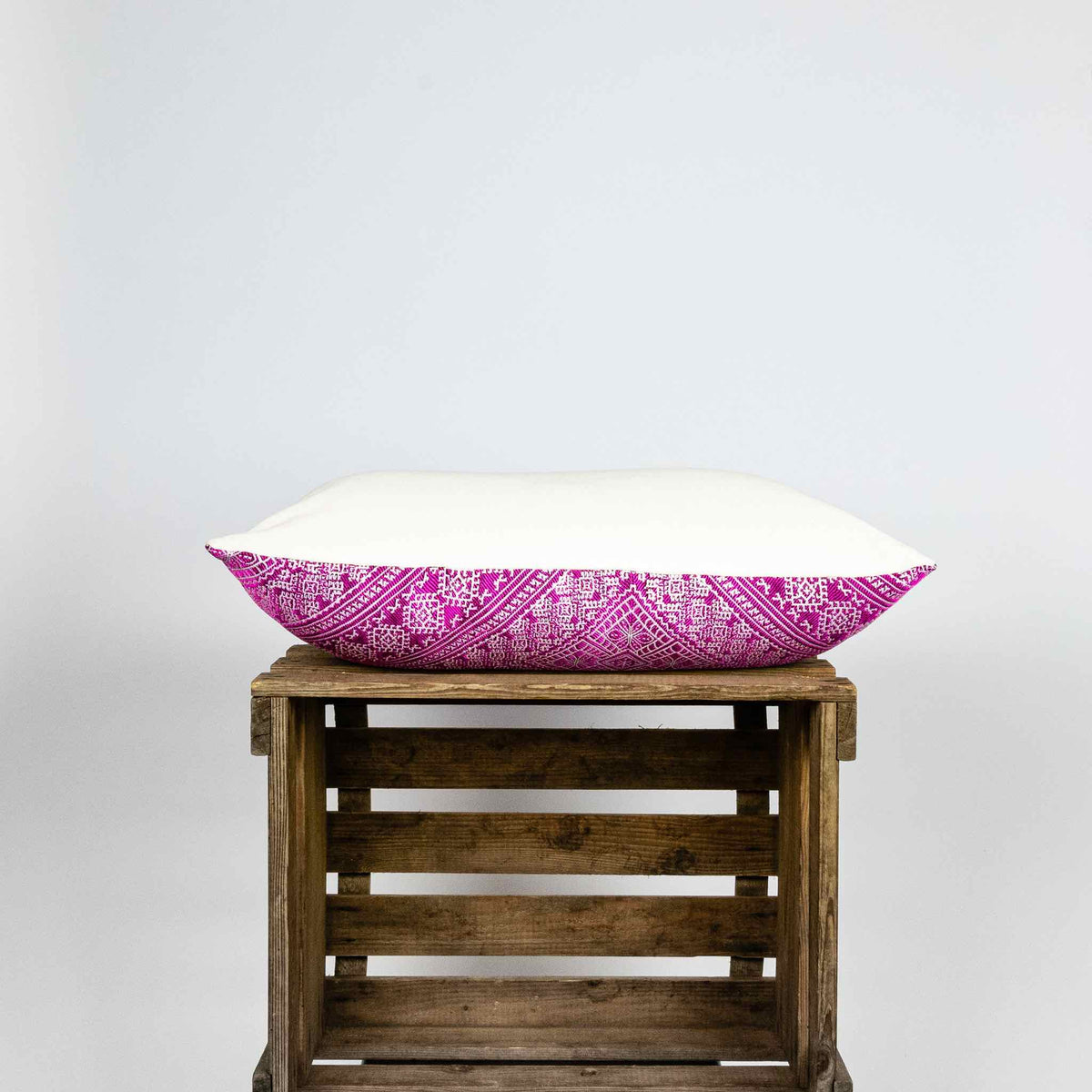 Fluffikon silk rectangular decorative pillow. The throw pillow is made from pink-white moroccan fabric shown from the side.