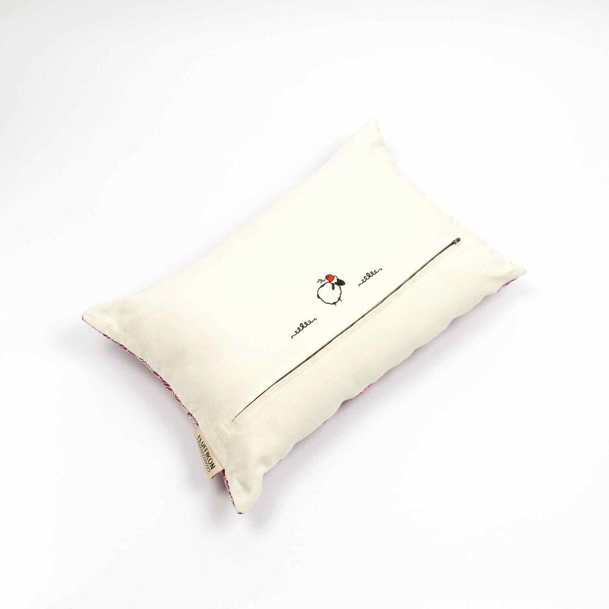 Fluffikon rectangular decorative pillow. The throw pillow is made from pink-white moroccan silk fabric. The pillow is shown from the back. Size 40x60 cm.