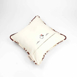 The back of a royal velvet pillow with piped edges.