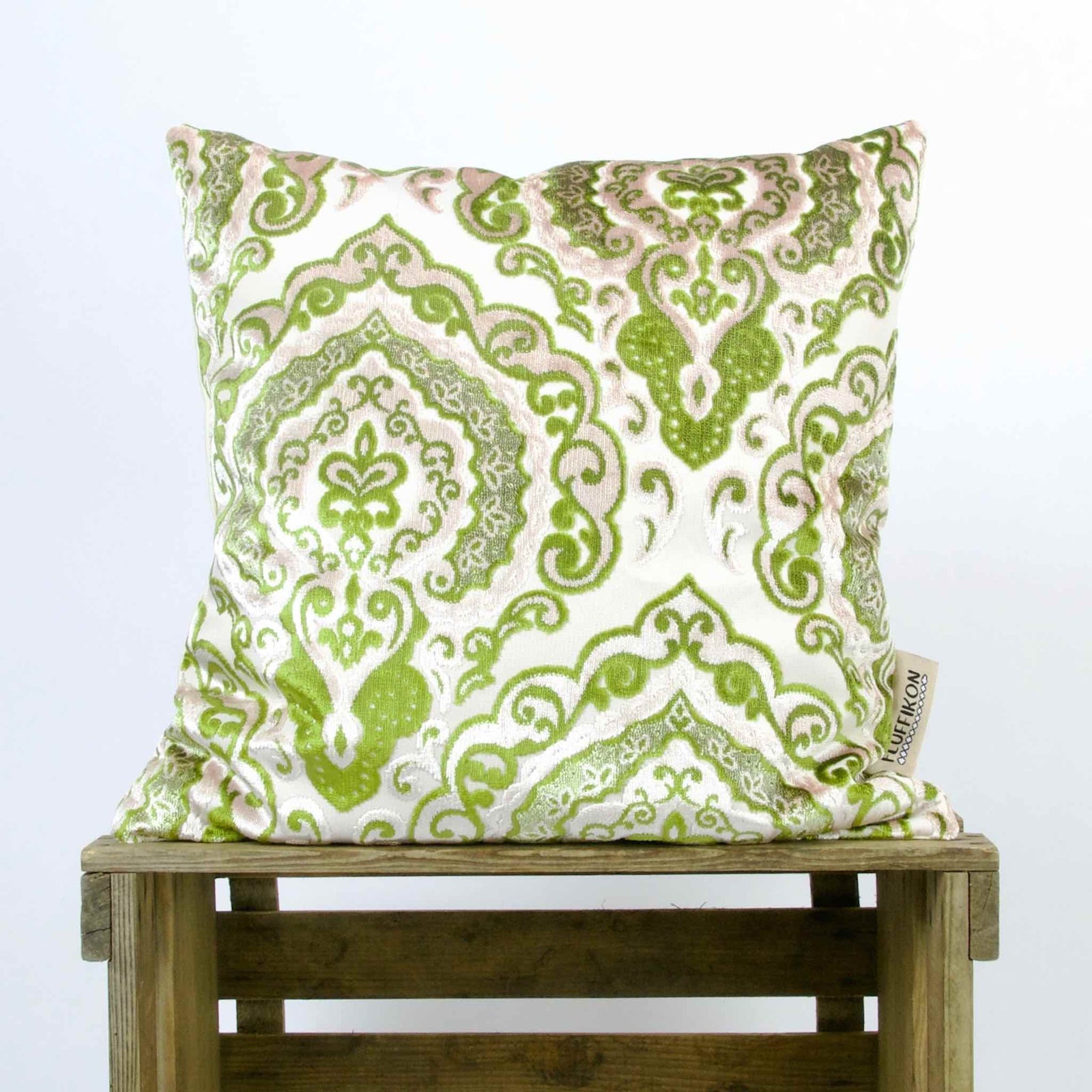Green Beige Sofa Pillow on a wooden box.