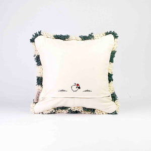 Back view of a checkered Moroccan Fluffikon pillow standing in front of a white background.