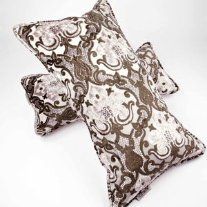 Large couch pillow made from brown beige velvet fabric. An oversized pillows is lying on a lumbar pillow.