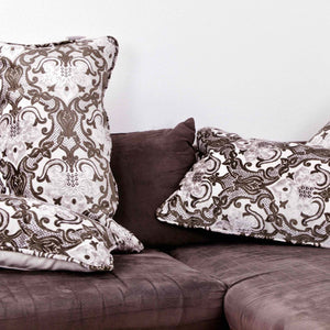 Two Large couch pillow with brown beige velvet on a brown couch.