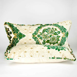 Two large pillows with oriental look. The pillows have a traditional green moroccan pattern on a beige canvas background. Two pillows are shown in front of each other.
