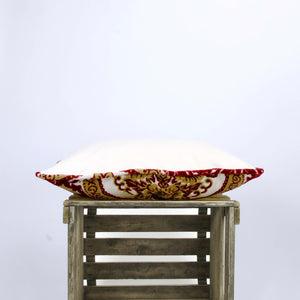 Side view of red-white velvet cushion showing the pillow piping or the piped edges,