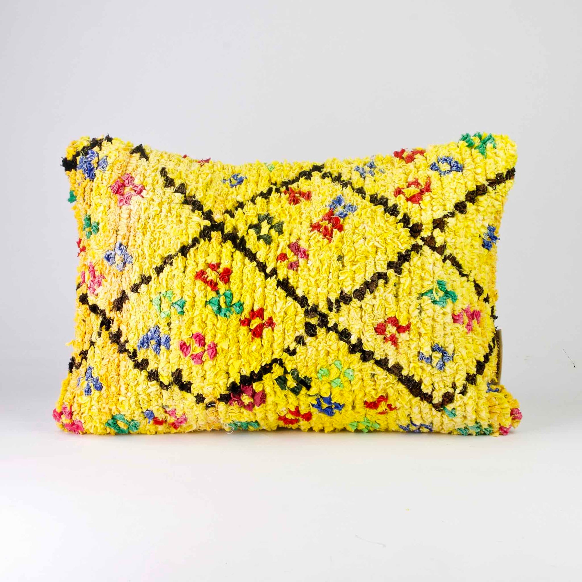 Yellow Boucherouite throw pillow. The yellow pillow has colorful dots.