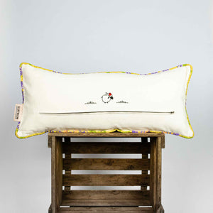 Back of yellow lumbar Brocade pillow on wooden box
