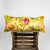 Yellow lumbar Brocade pillow on wooden box