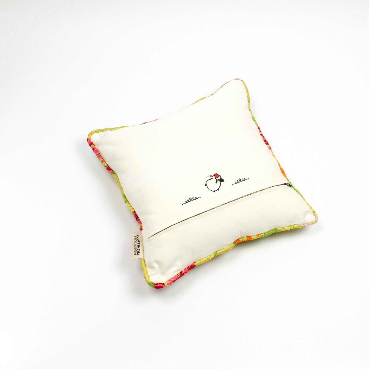 Back of yellow square Brocade pillow on the ground.