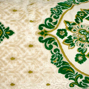 Zoom on a large pillow with oriental look. The pillow has traditional green moroccan pattern on a beige canvas background. 