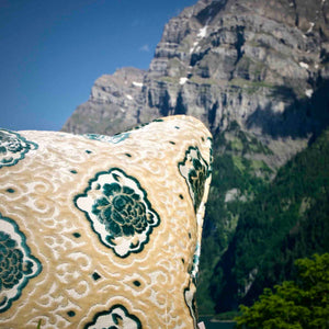 Zoom on oversize throw pillow in front of mountains
